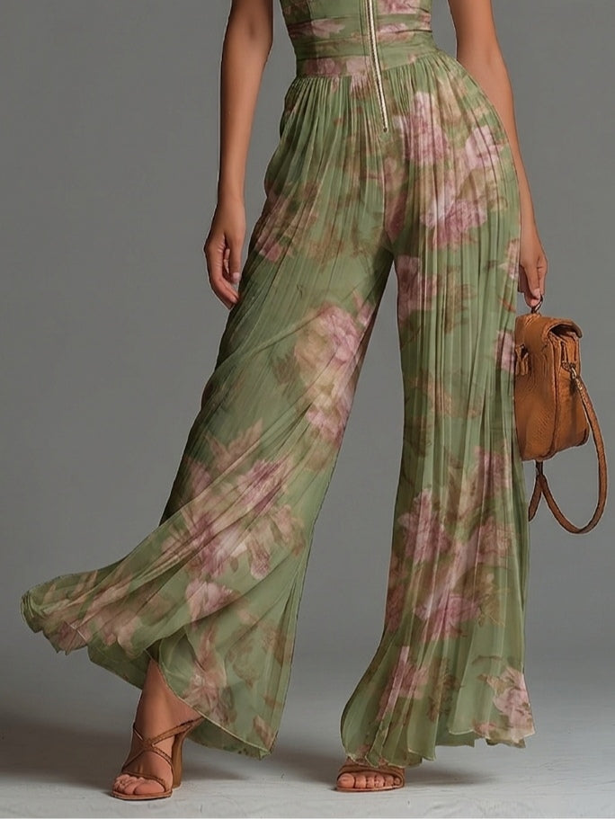 Mono de gasa verde con estampado floral, cuello en V, sin mangas, cierre al frente, plisado y pierna ancha