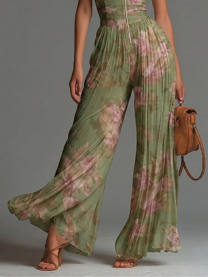 Mono de gasa verde con estampado floral, cuello en V, sin mangas, cierre al frente, plisado y pierna ancha