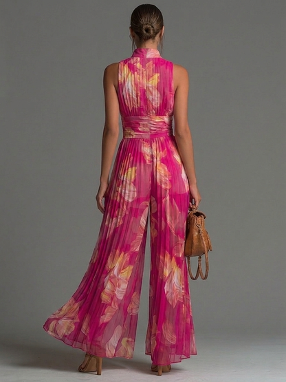 Mono de gasa fucsia con estampado floral, sin mangas, con cremallera, detalles plisados y pantalones de pierna ancha